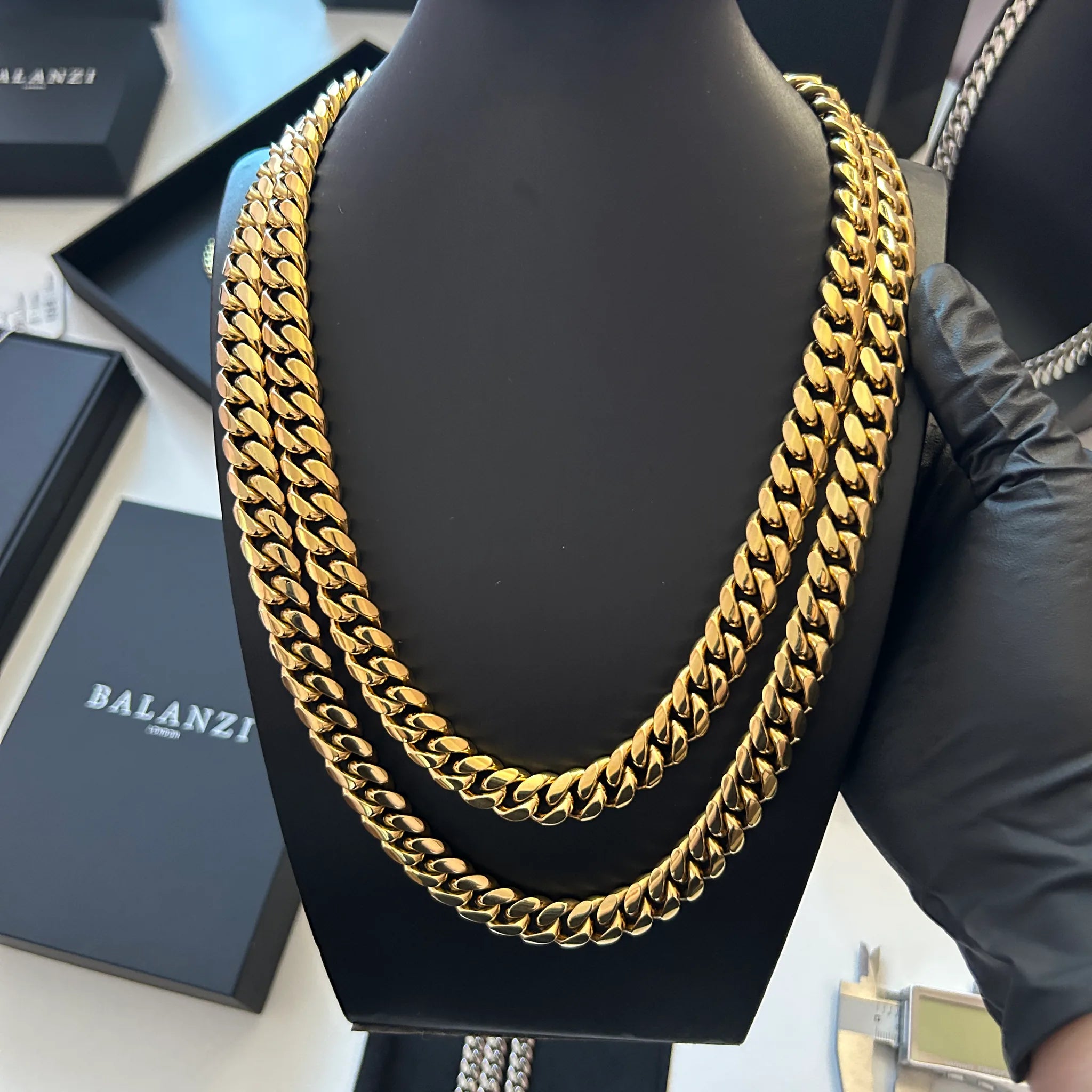 BALANZI 12mm gold Cuban link chain stack — product close-up