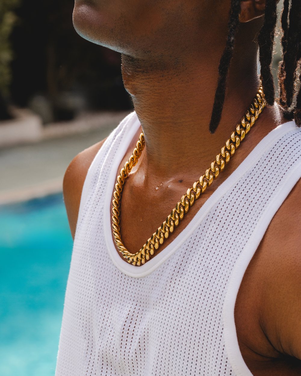 The 12mm Cuban link worn at the collar over a white tank